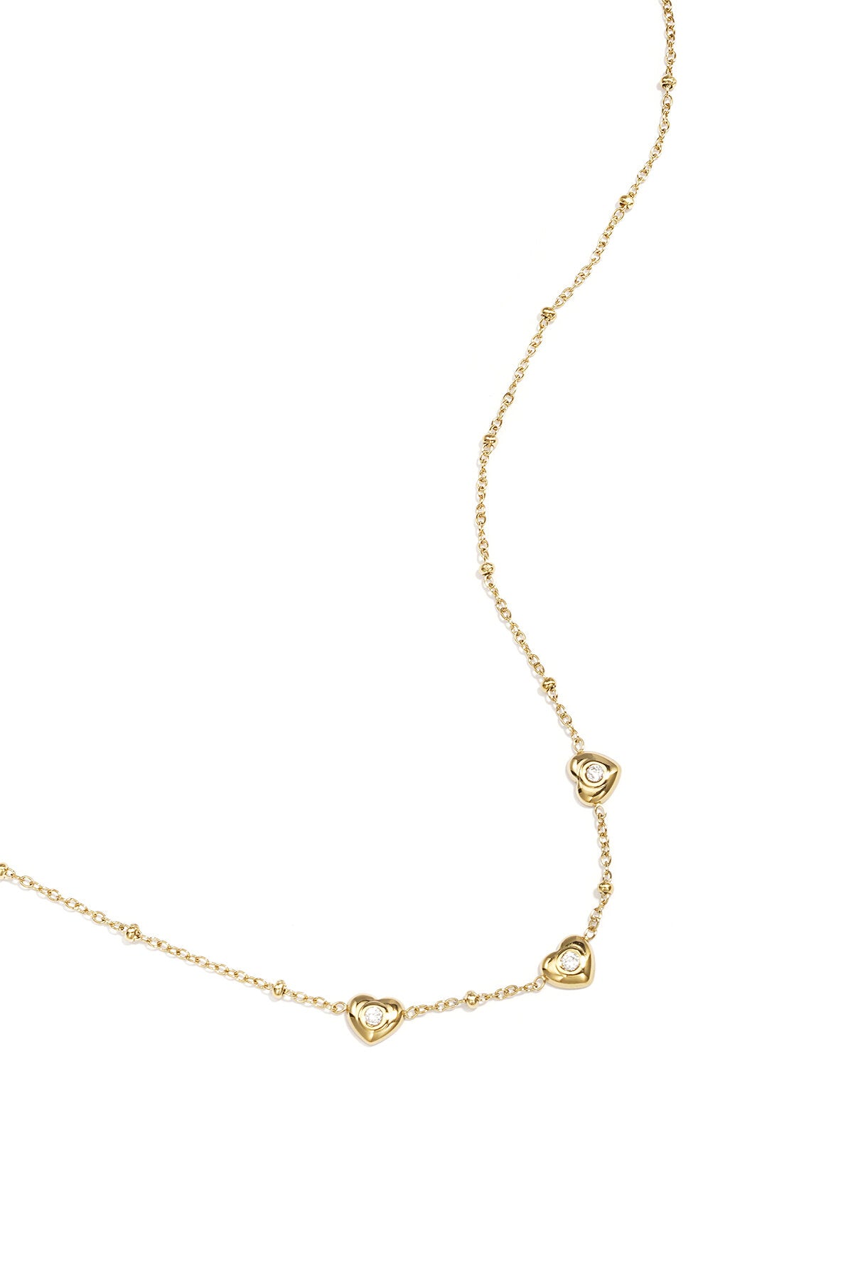 Ketting met bolletjes en hartjes met steen
