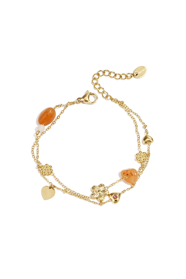 Bedelarmband met oranje kralen, bloemen en hartjes